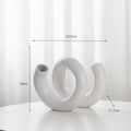 White ceramic vase with curved loop opening and arched stems