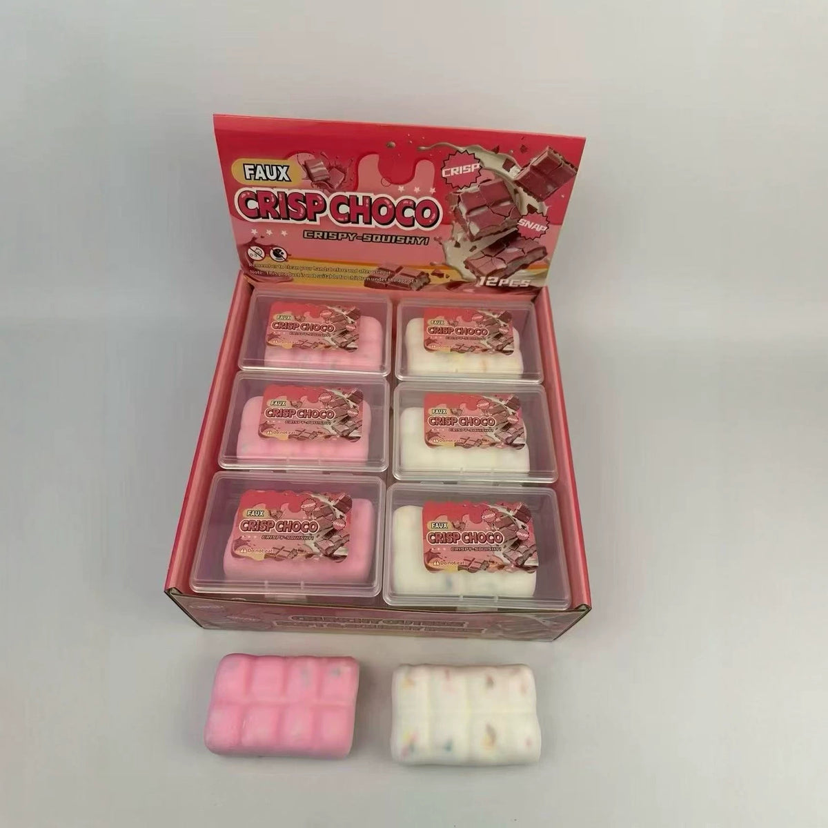 Pink display box with clear trays of faux chocolate squeeze toys, plus two bars outside