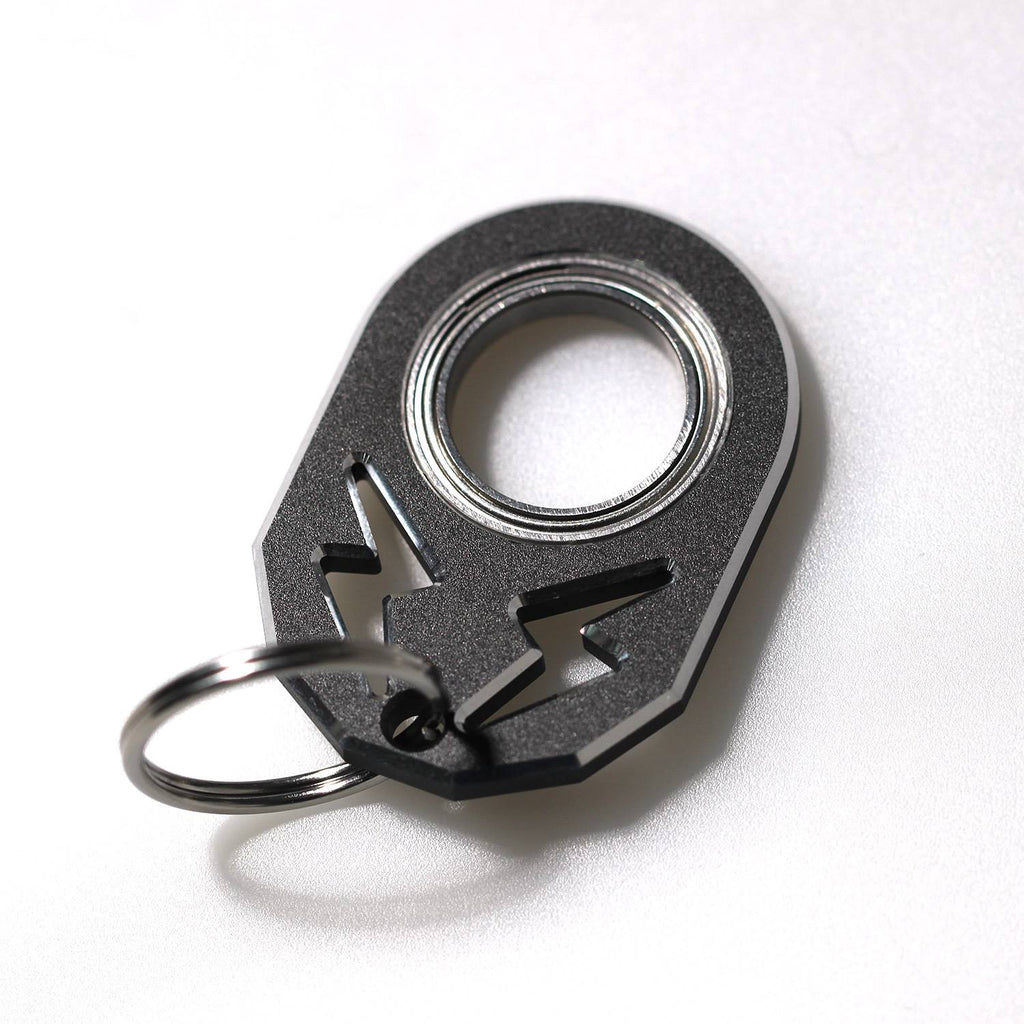 Black rotating key chain with silver ring and arrow-style hook.