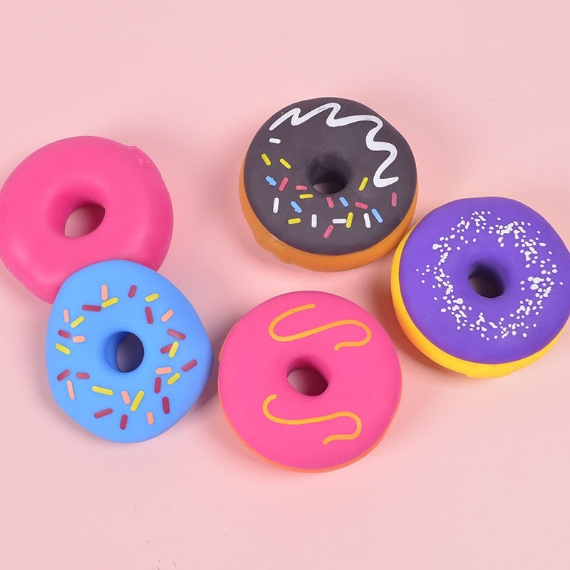 Colorful squishy donut stress-relief toys with glazed frosting sprinkles in pink, blue, purple, orange