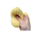 Yellow peanut squeeze stress toy held single piece up against white