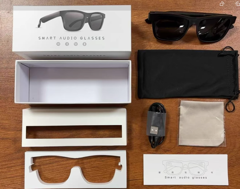 Smart audio glasses set with black sunglasses, charging cable, and storage pouch