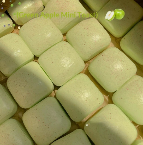Light green mini toast squishy squeeze toy, glossy cubes in a close-up pile