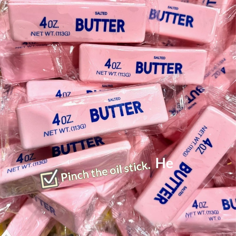 Pink “Butter” squishy stick stress toys stacked in clear bag