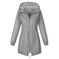Women’s windproof trench coat in gray with front zipper and striped hood lining.