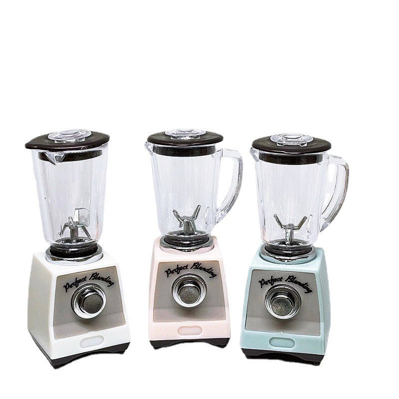 Toy blender set: pink, white, and blue units with clear jars, black lids, and dials