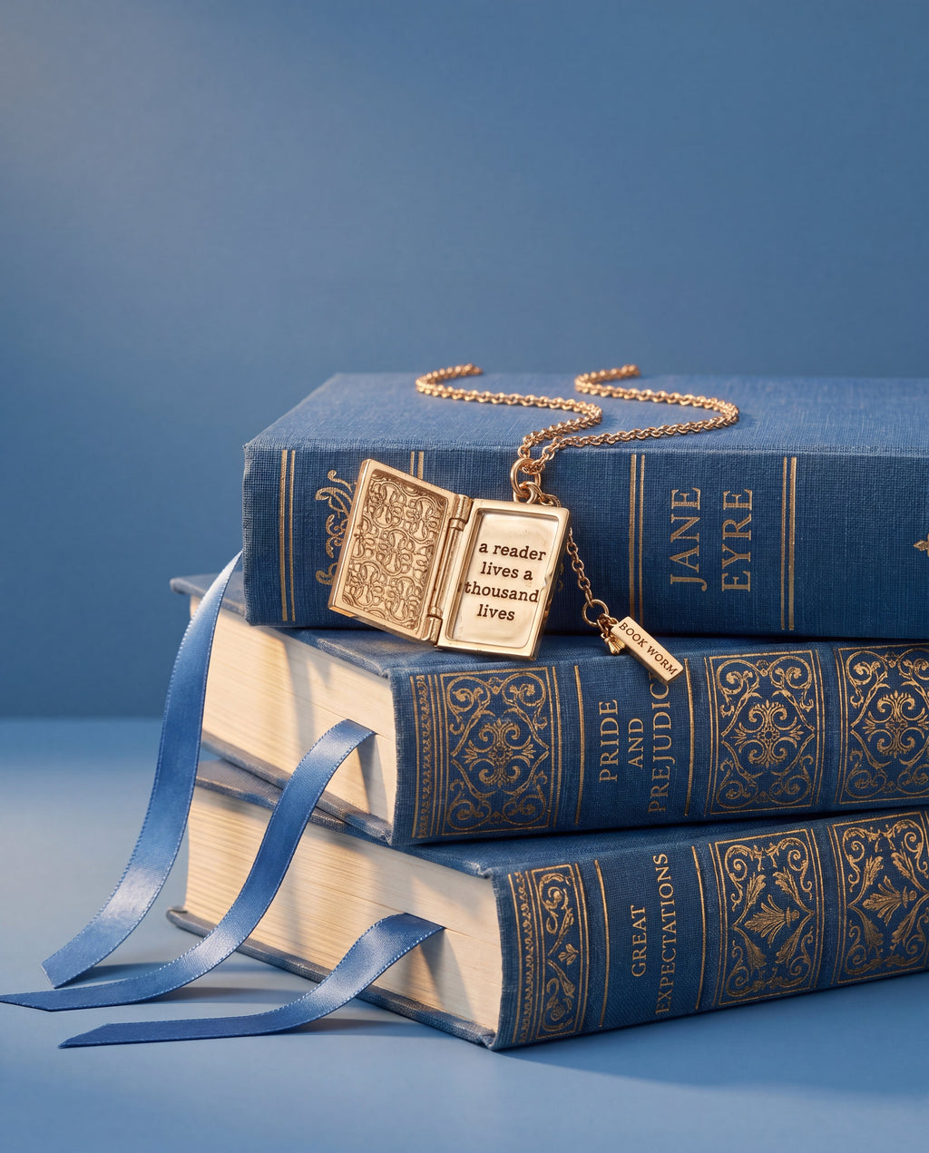 Gold book club locket pendant necklace on book stack display