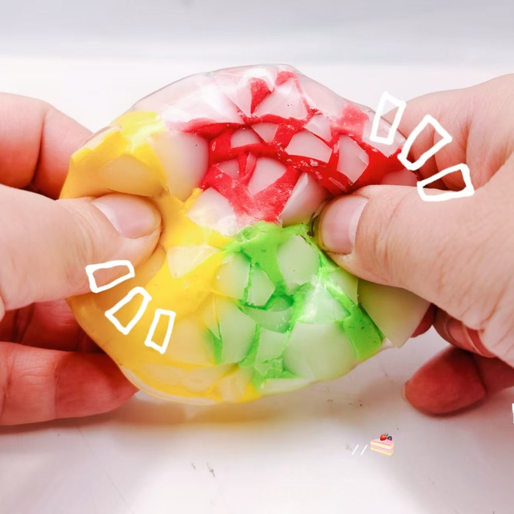 Multicolor crispy sphere stress-relief squeeze toy with crackle pattern, held