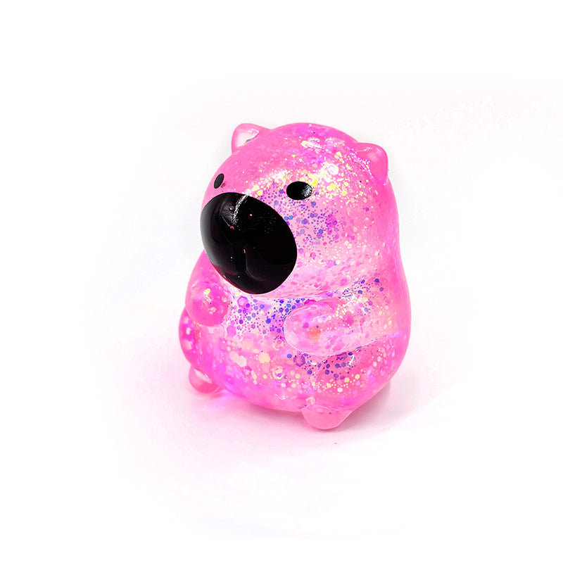 Pink capybara-shaped squishy candy stress toy, glittery translucent body with black face