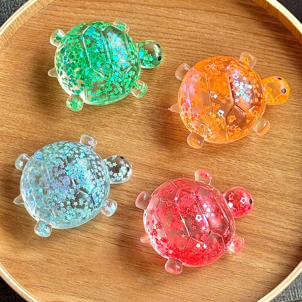 Assorted glitter bubble-bead sea star stress toys in green, orange, blue, red