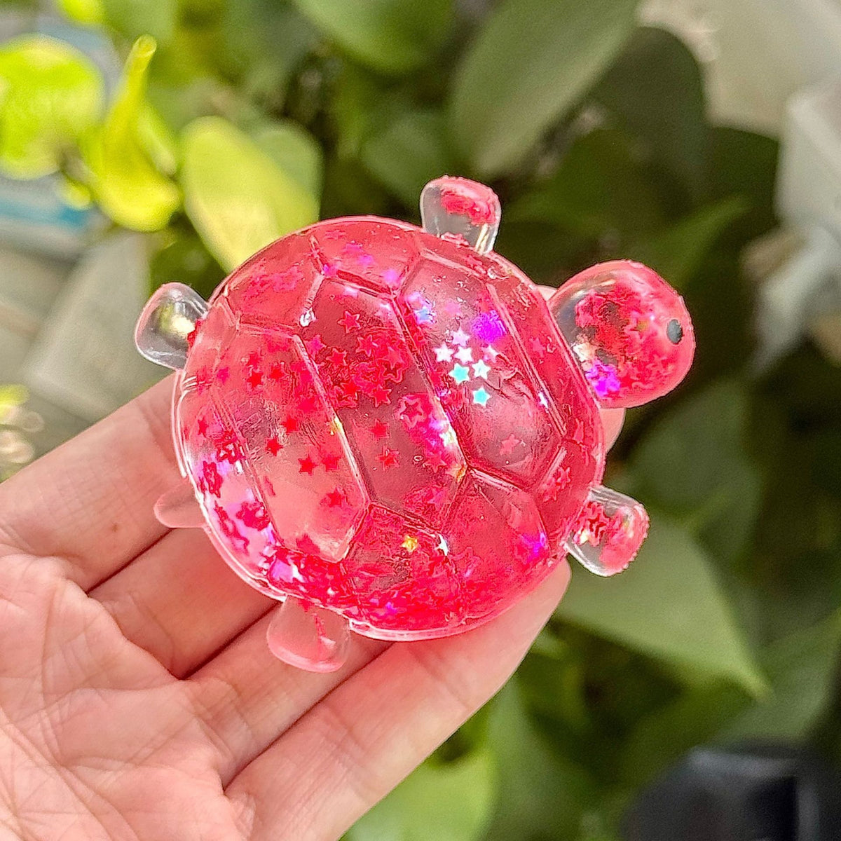 Pink glitter bubble-bead sea star stress toy, slow-rebound, held