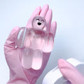 Transparent pink robot stress relief squeeze toy, held with another hand in frame