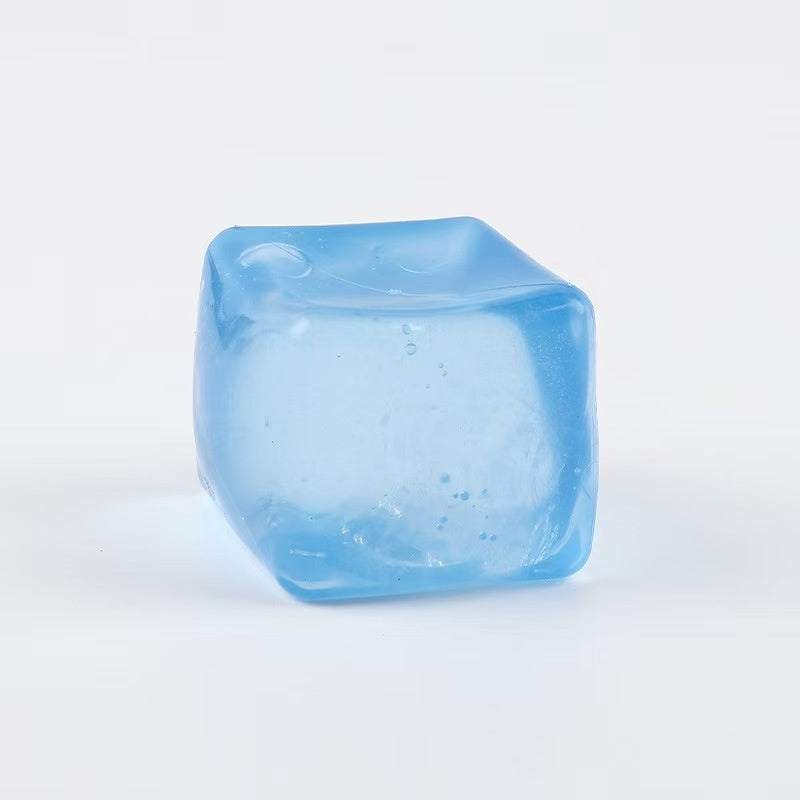 Light blue translucent cube squeeze stress-relief toy with small specks inside.