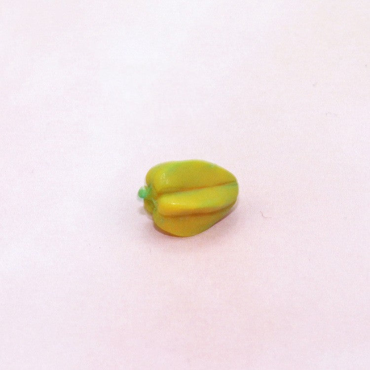 Single yellow toy banana piece on a light background