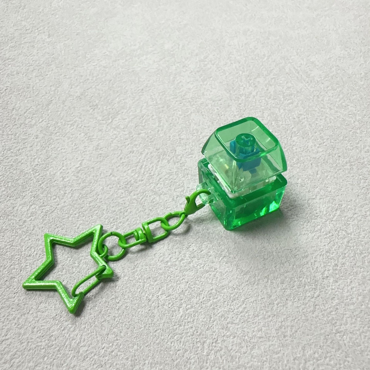 Green cube mechanical keyboard stress-relief keychain with star charm and chain