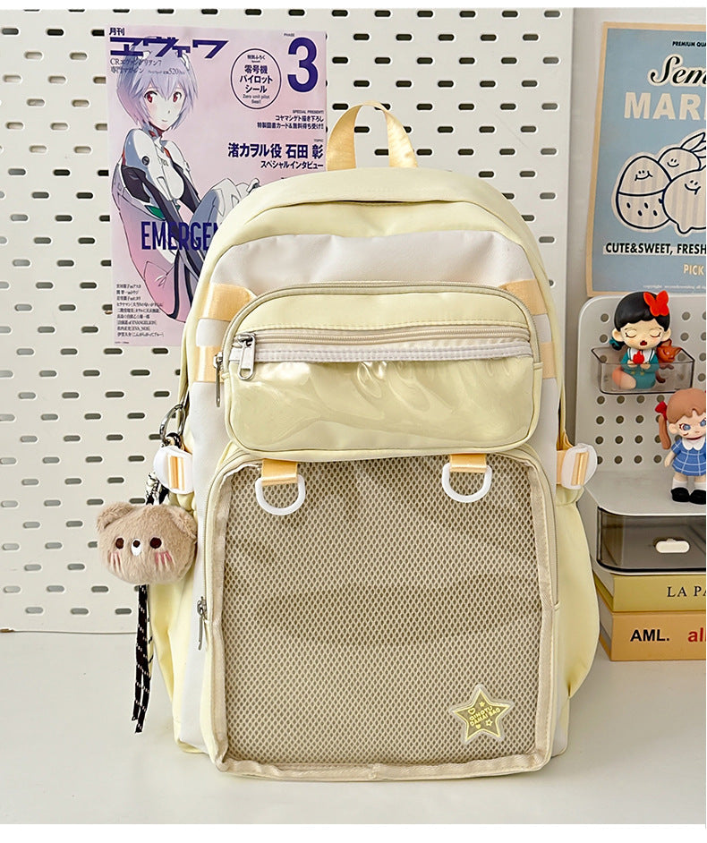 Yellow nylon backpack with front zip pocket, mesh panel, and star patch