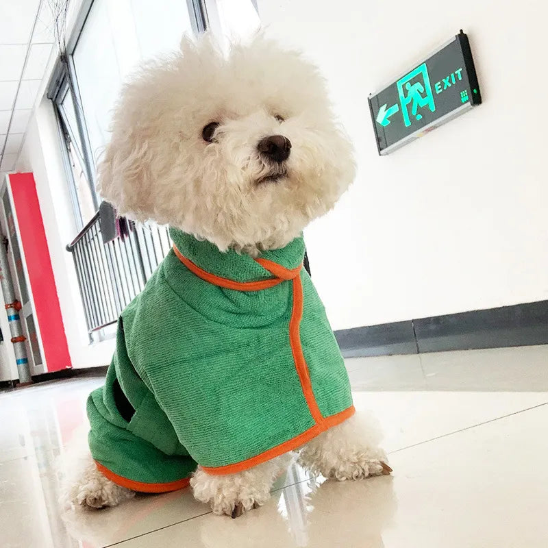 Green pet bathrobe towel on white dog with orange trim and neck strap