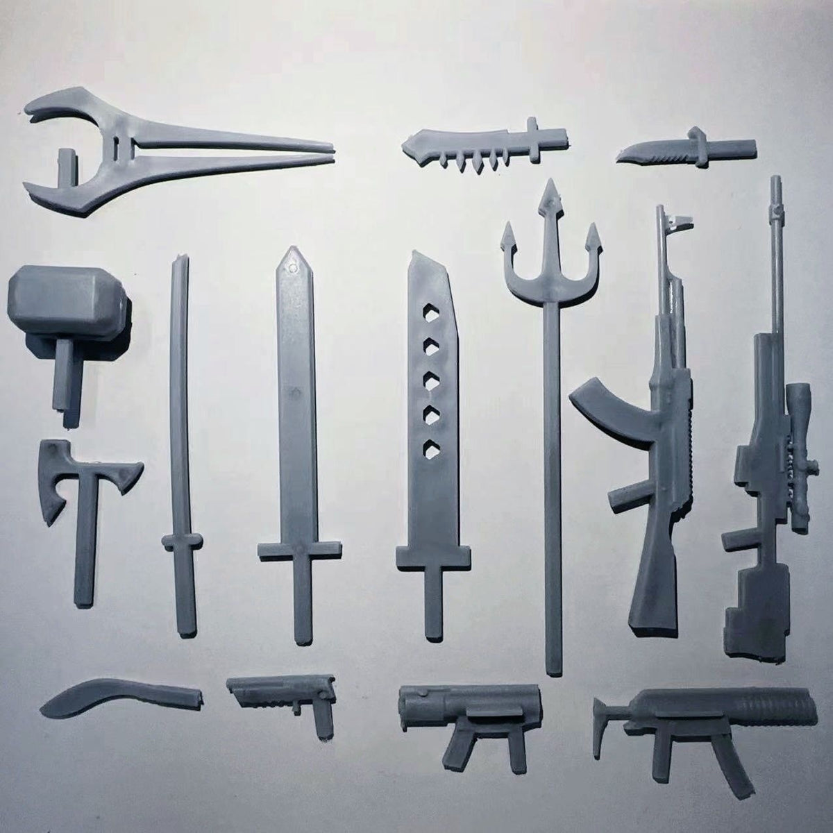 Gray weapon and accessory parts sprue for assembling a multi-joint robot action figure