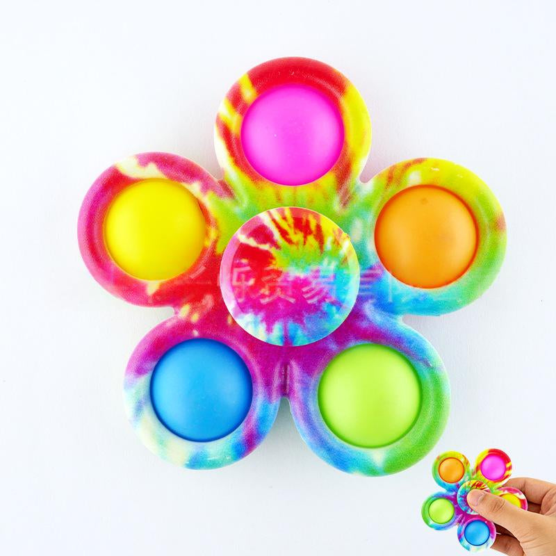 Rainbow tie-dye fidget spinner stress-relief toy with neon pink center and multicolor caps