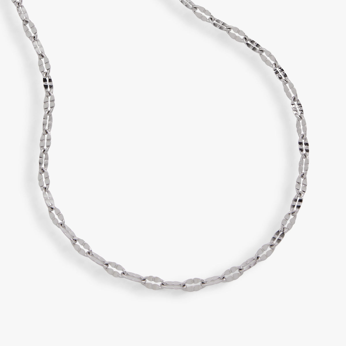 Silver multi-faceted chain anklet, close-up view of repeating faceted links