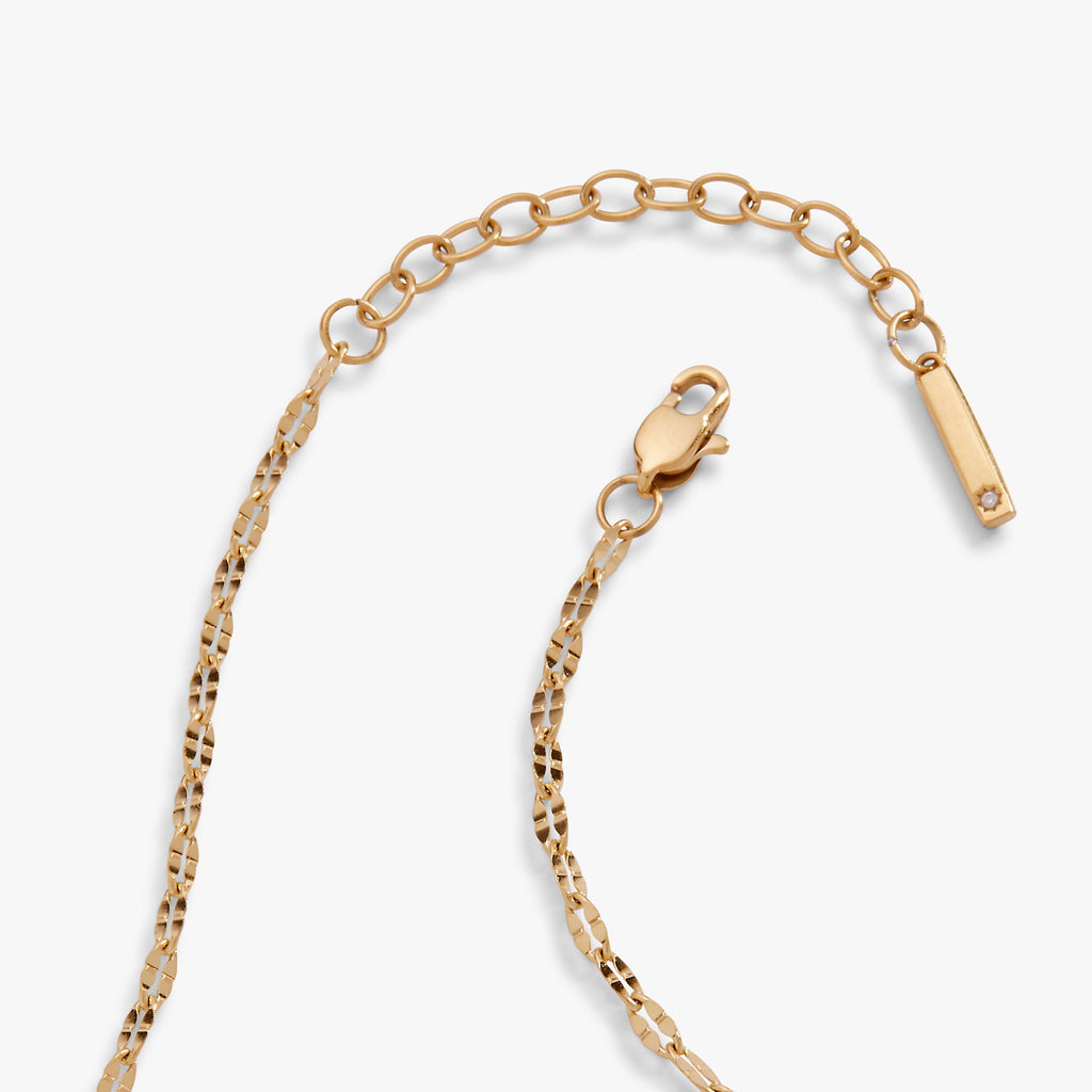 Gold chain anklet with heart-shaped connector and bar tag charm
