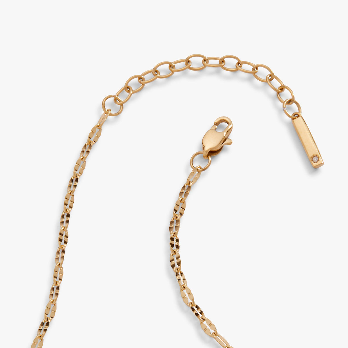Gold chain anklet with heart-shaped connector and bar tag charm