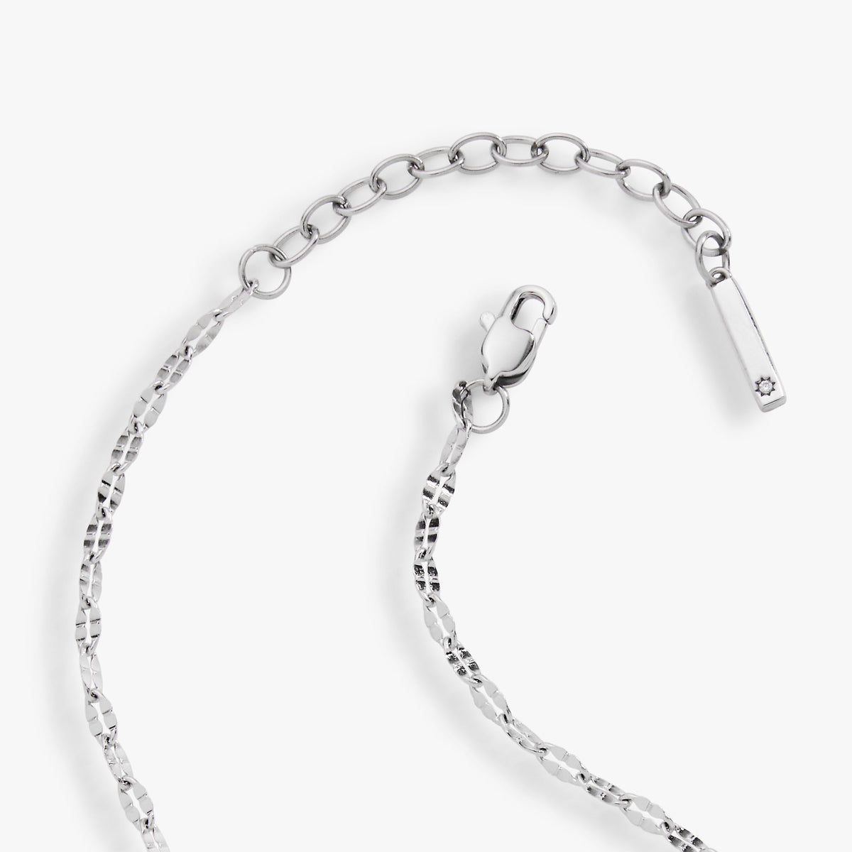Silver chain anklet with heart-shaped clasp and dangling tag charm