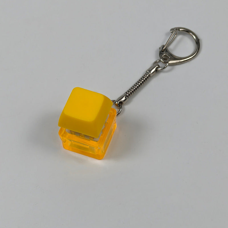 Yellow square finger-popping keychain toy with spring chain and snap buttons