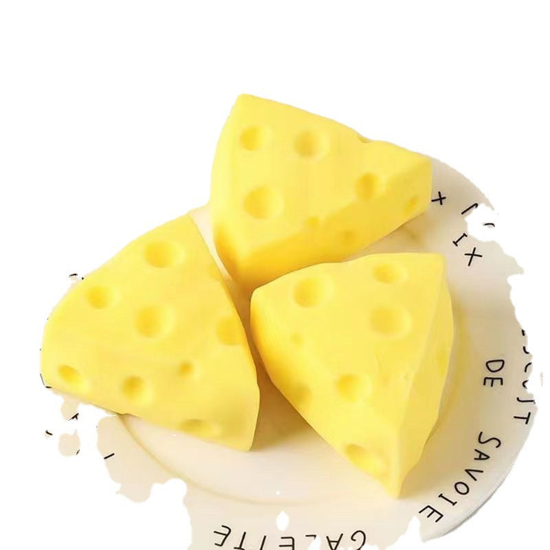 Set of three yellow cheese wedge squishy toys with round holes