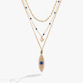 Gold evil eye pendant necklace with layered chains and blue bead accents