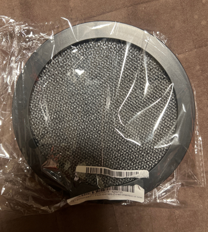 Portable desktop range hood smoke remover filter element, round dark mesh in plastic wrap