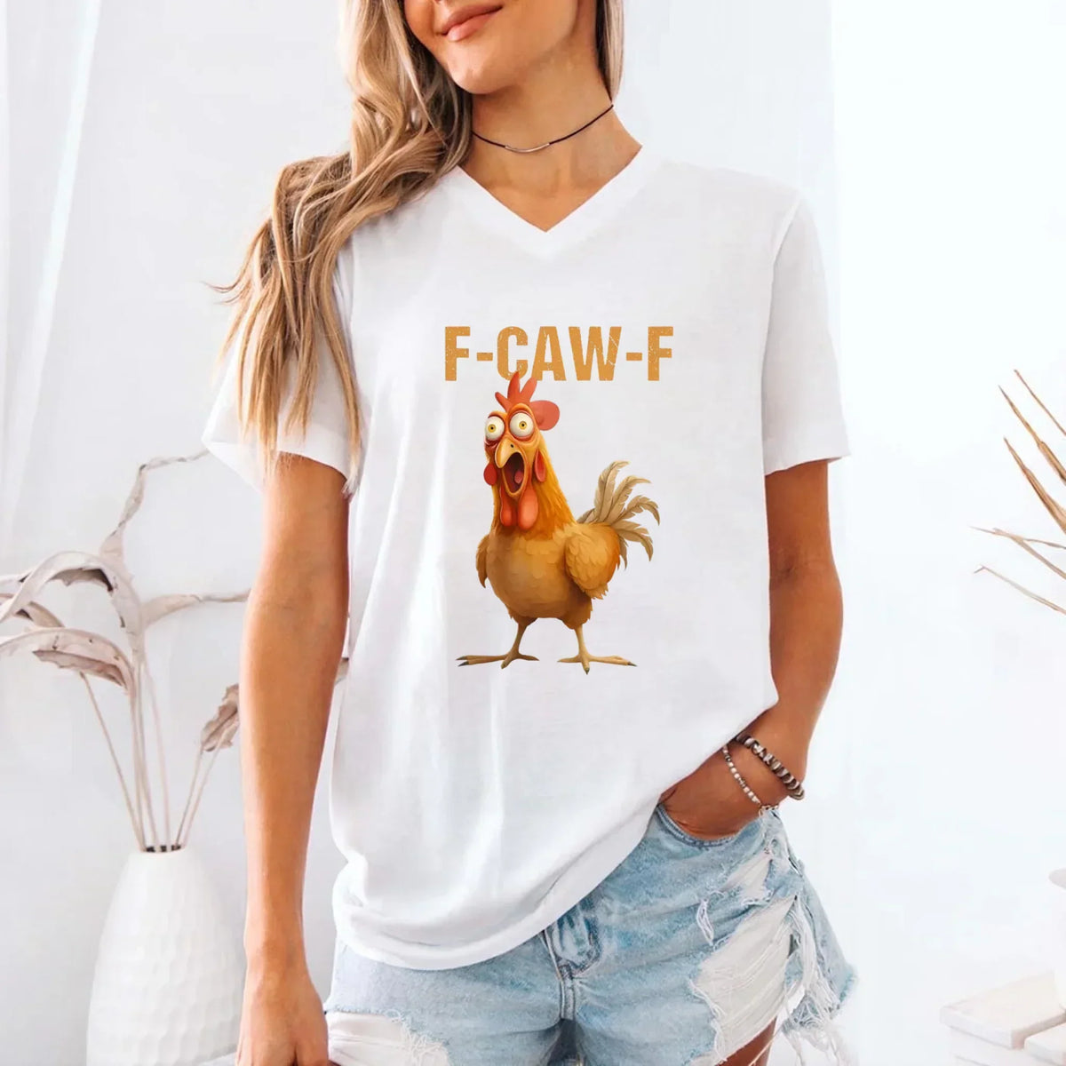 White v-neck T-shirt with rooster graphic and "F-CAW-F" text