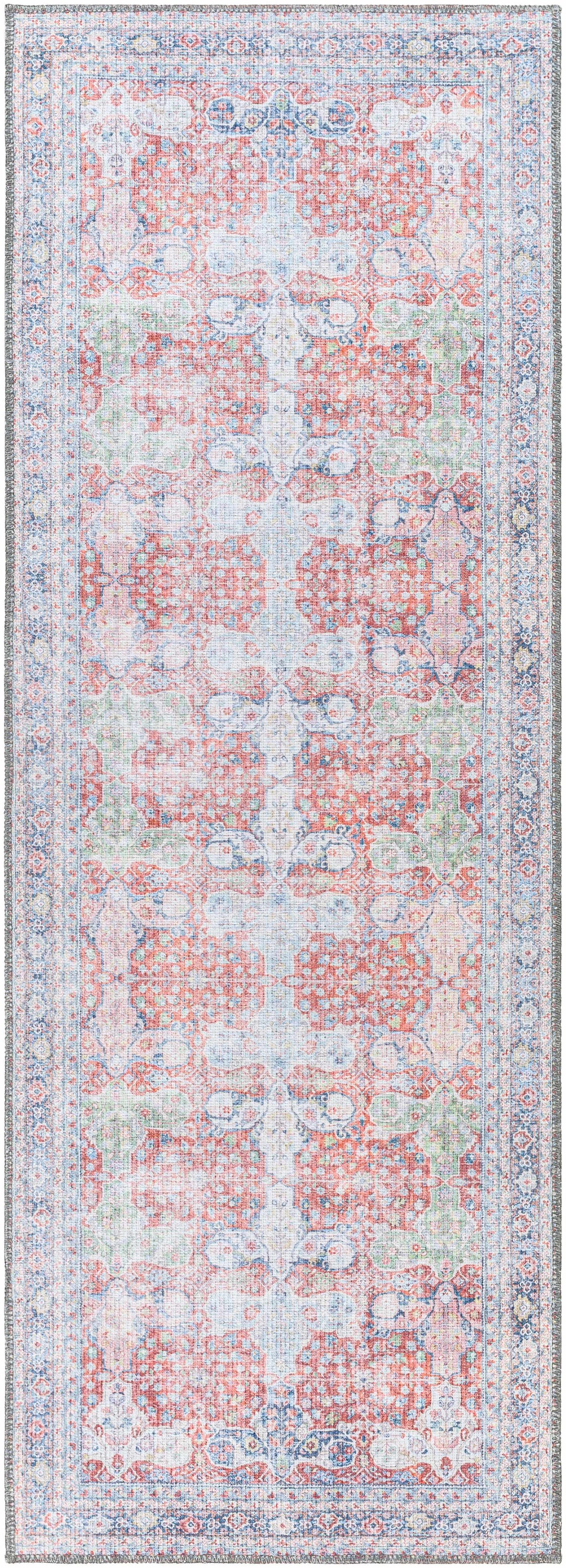 Narrow vintage area rug with blush, sage, and navy ornate distressed pattern