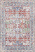 Flat-lay view of vintage area rug with blush, sage, and navy medallion patchwork