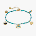 Gold-tone turquoise bead anklet with evil-eye, hamsa, sun and yin-yang charms