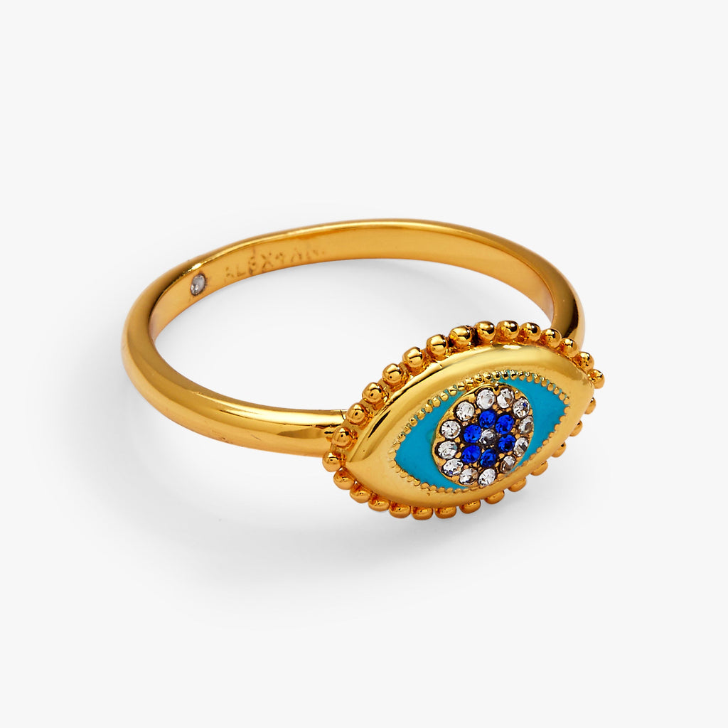 Gold evil eye healing stone ring with oval blue eye motif and faceted crystal cluster