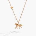 Gold horse pendant necklace with small flower charm and horse figure on chain