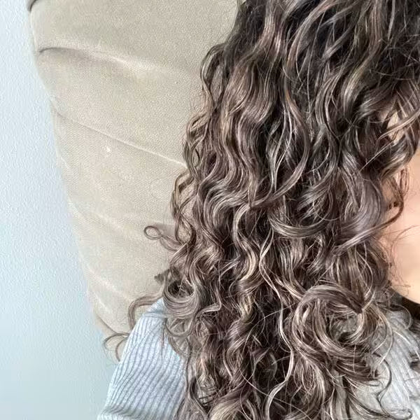 Defined, glossy curly hair texture with visible curl separation