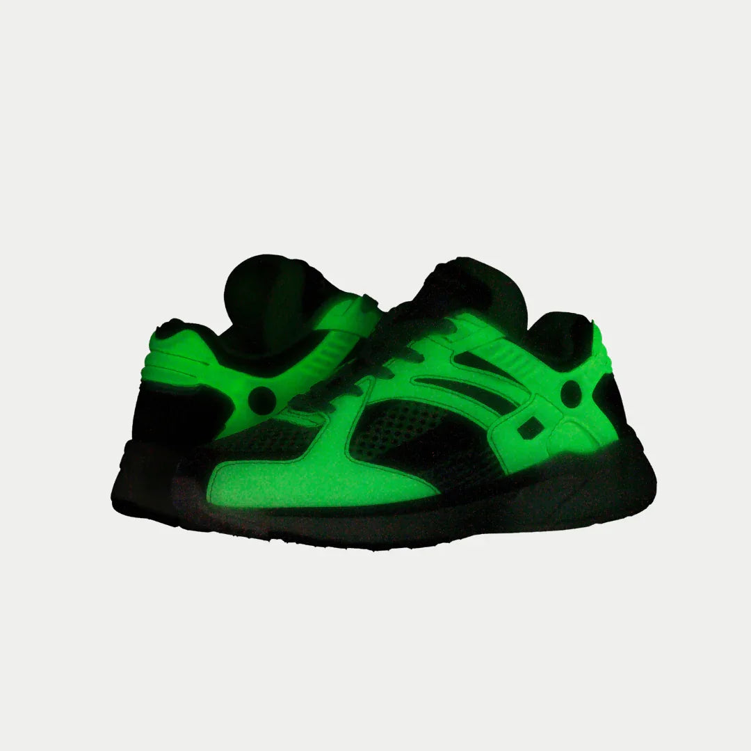 Kids neon yellow and black low-top light-up sneakers glowing green, front angle