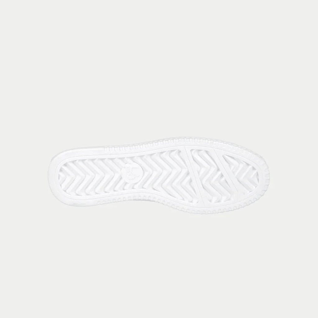 Kids white lowtop sneakers with textured rubber outsole tread