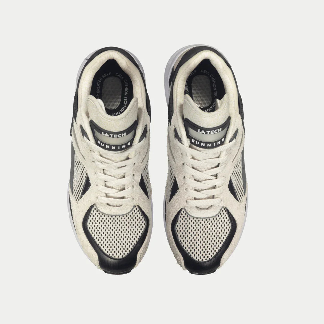 Pair of white and black lowtop sneakers showing lace-up uppers and mesh toe panels