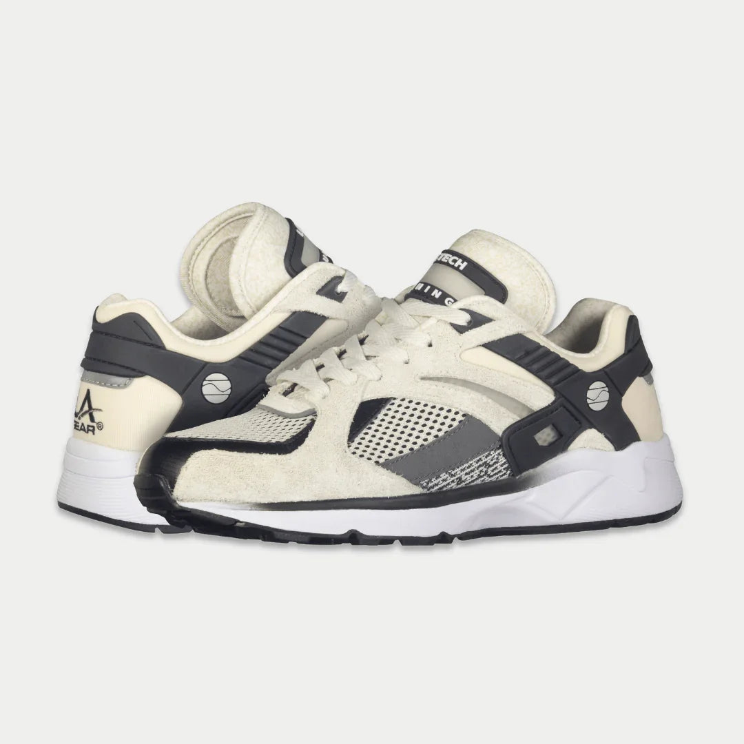 White and black lowtop lace-up sneaker with mesh side panels and thick midsole