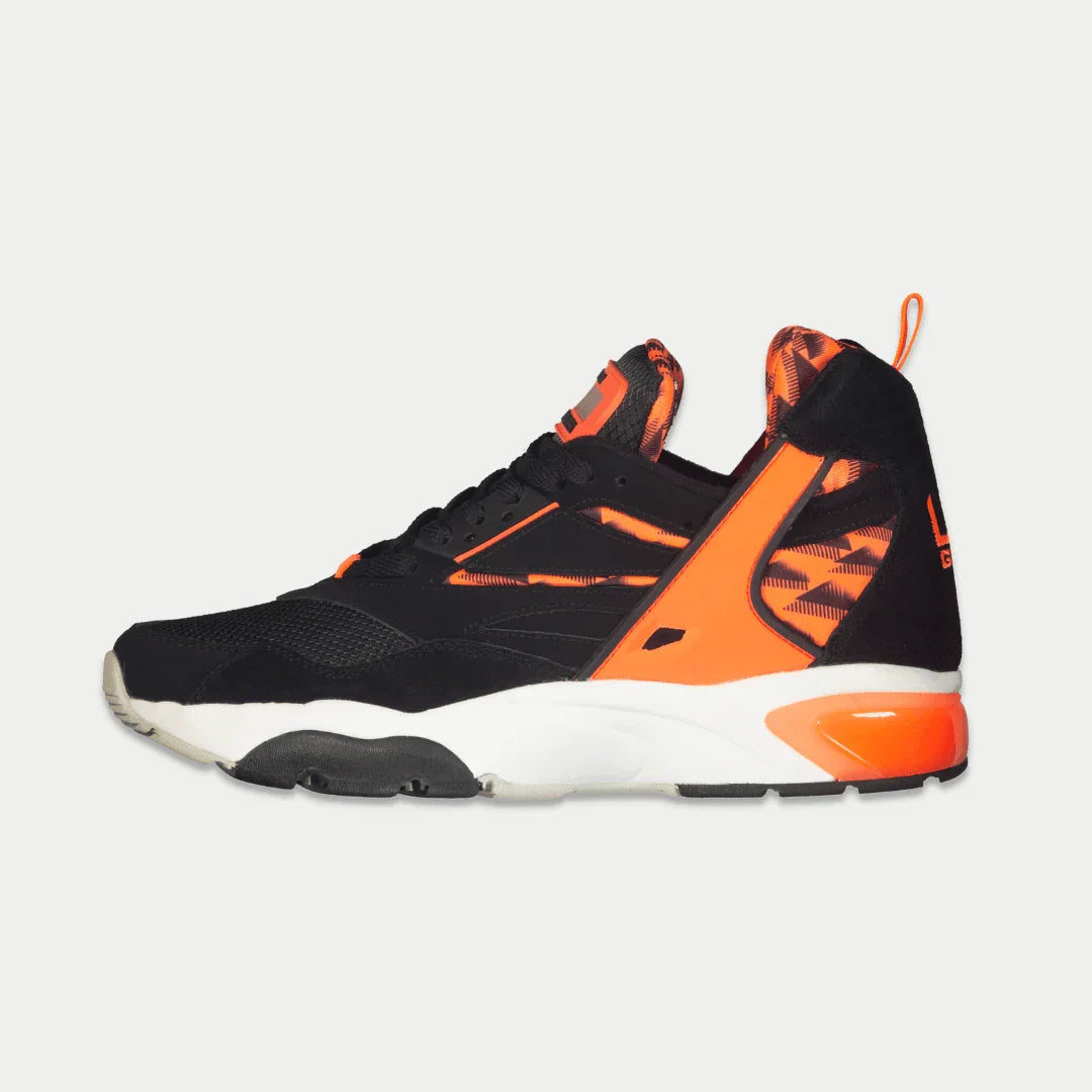 Men's black mid-top sneaker profile with neon orange trim and visible light-up detail