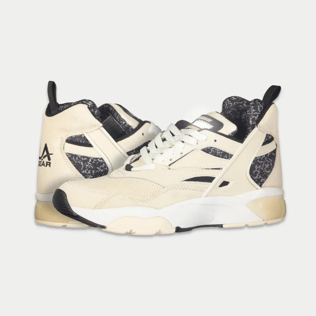 Men's off-white and black mid-top sneakers, side profile with white laces
