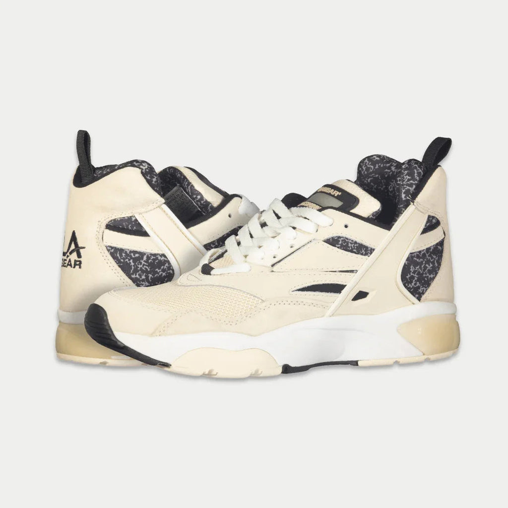 Men's off-white mid-top sneakers with black speckled panels and lace-up front