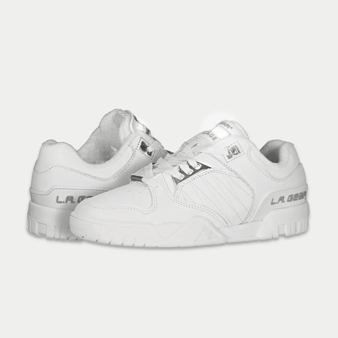 White low-top sneaker, angled side view, lace-up with stitched branding details