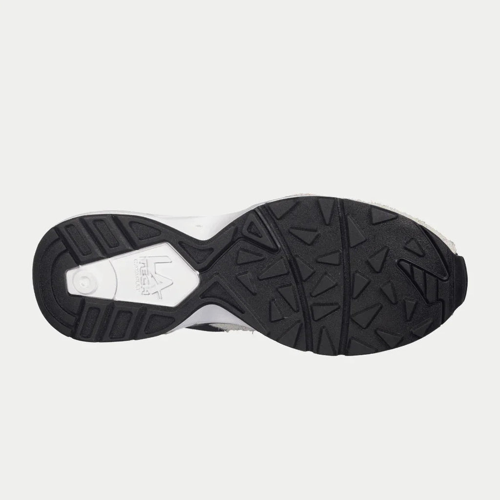 Women’s sneaker outsole in black and white with textured tread.