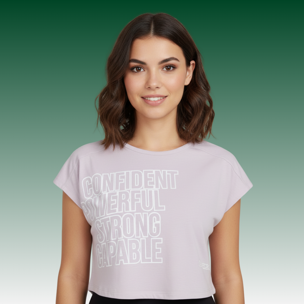 Lavender-pink cropped logo tee with stacked motivational text on front