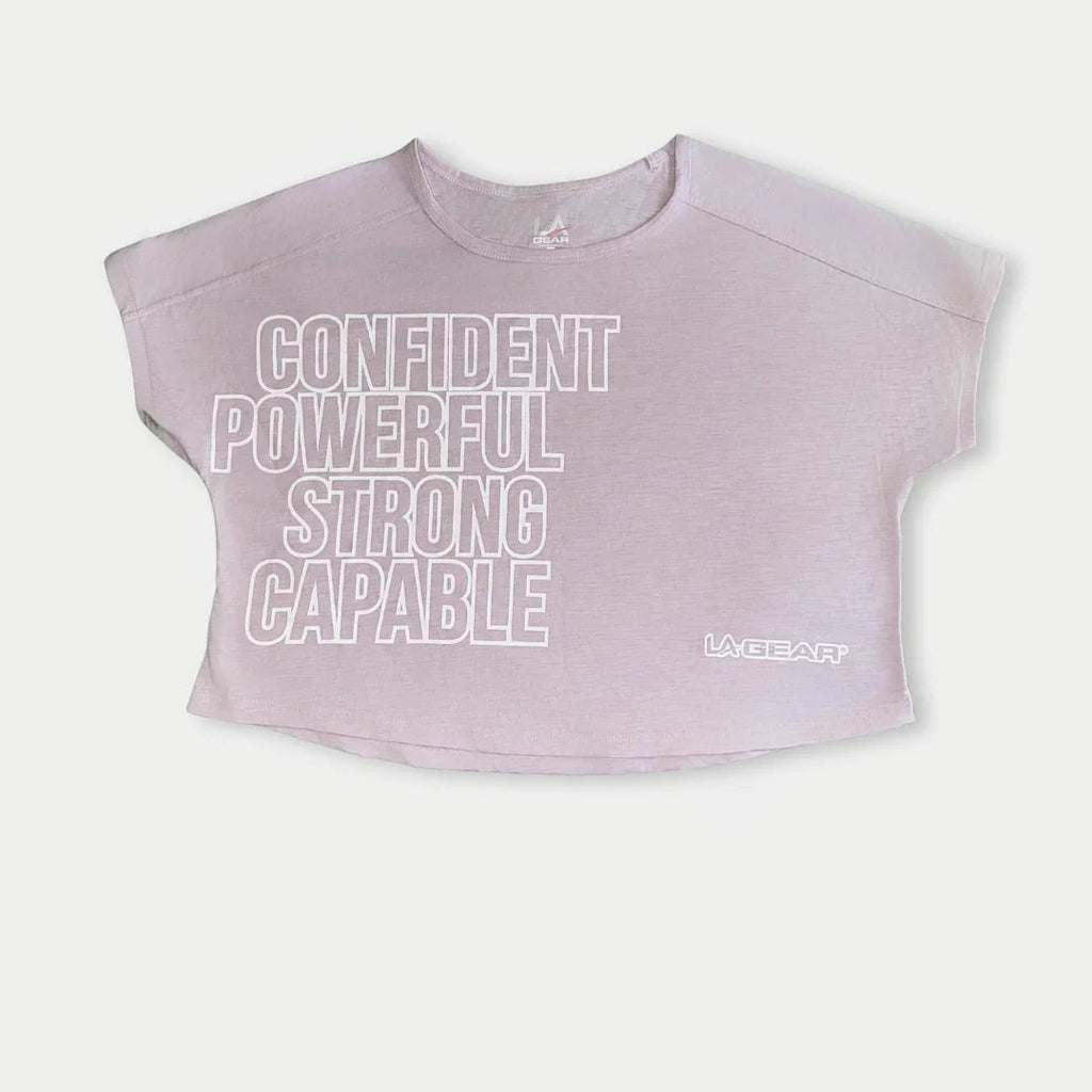 Lavender-pink cropped logo tee with LA Gear mark and stacked text front