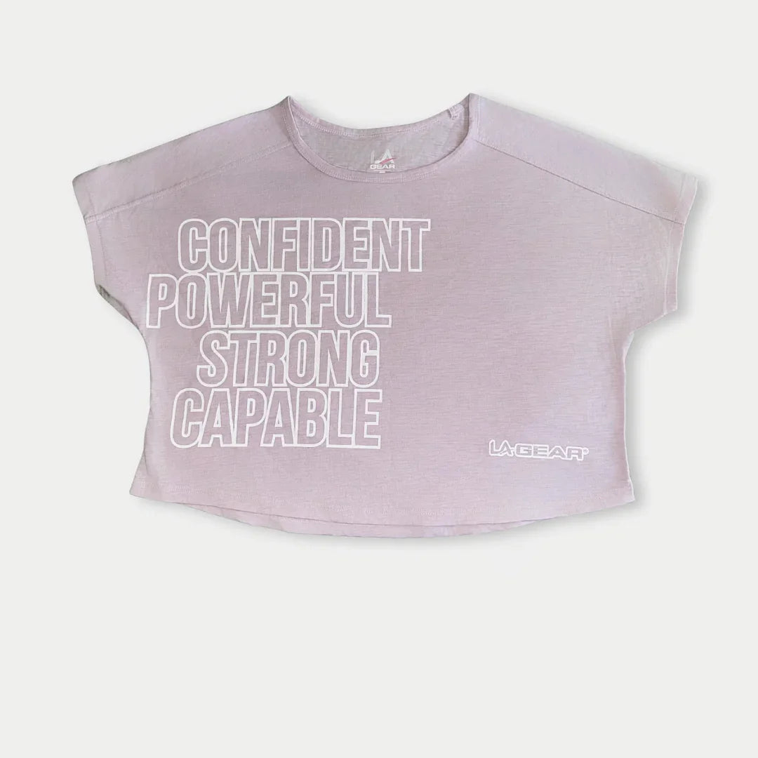 Lavender-pink cropped logo tee with LA Gear mark and stacked text front